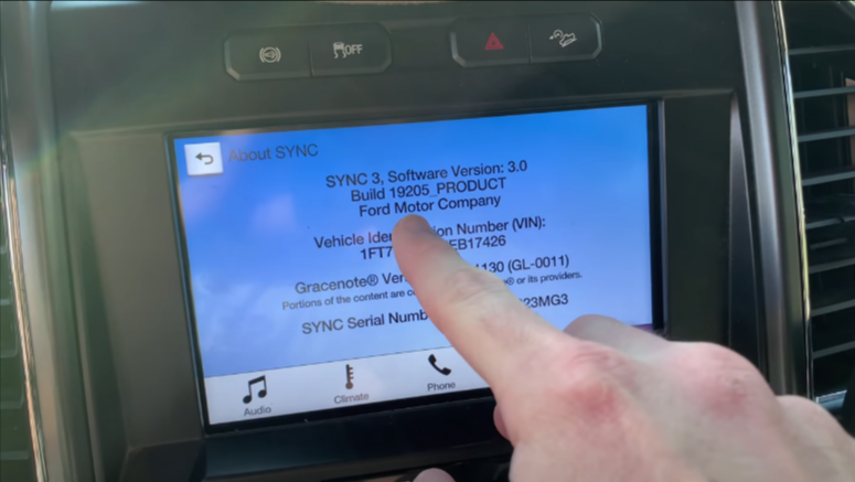 Close-up of a car's SYNC 3 infotainment system showing software version and vehicle details.